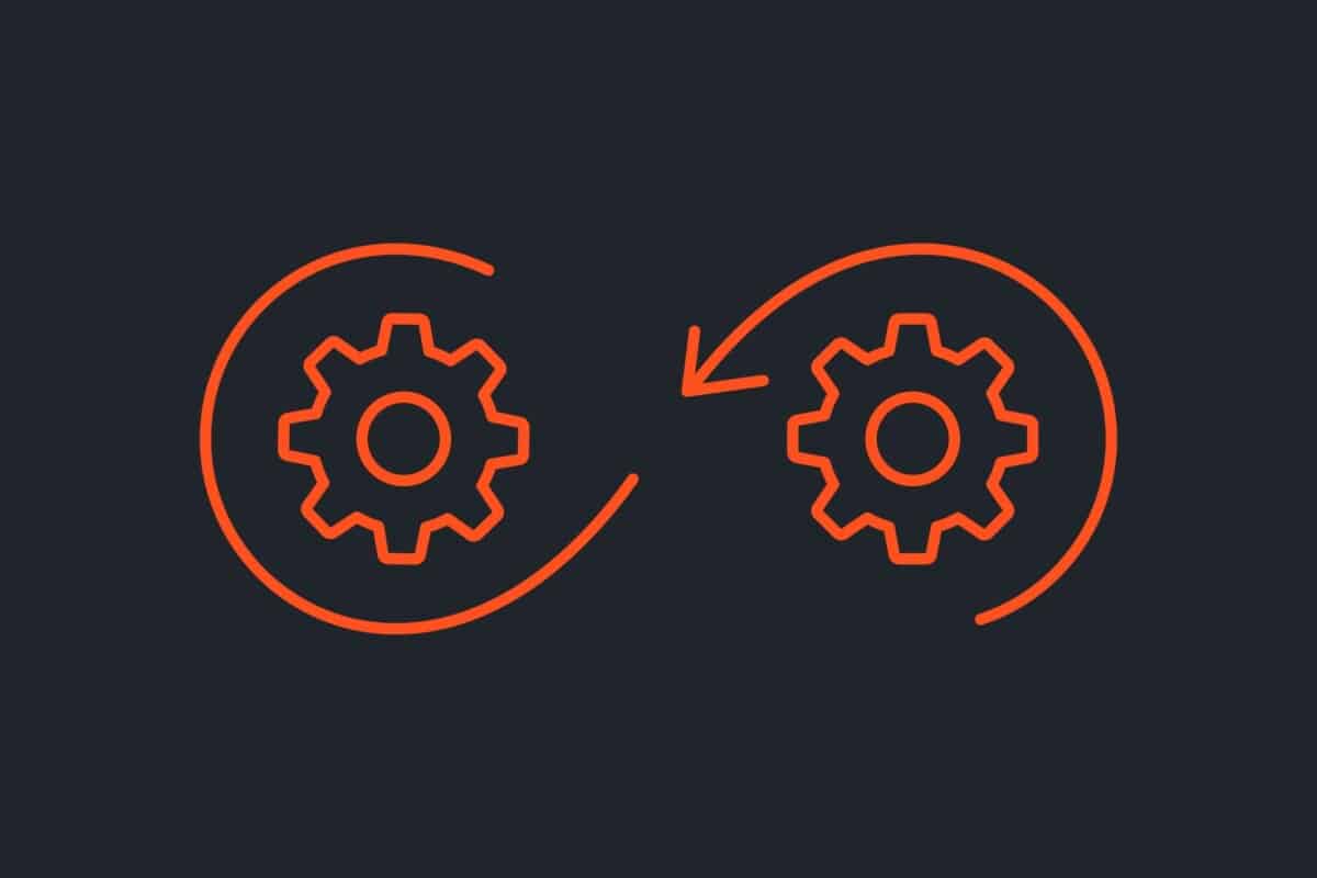 Illustration of two orange cogs turning with arrows set against a dark background to demonstrate the continuous momentum of WordPress development