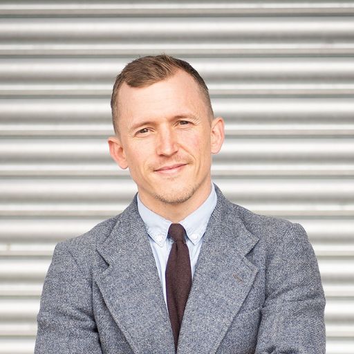Piers looking at camera in front of an industrial backdrop