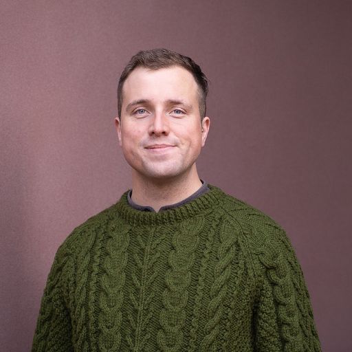 Steve looking at camera in front of a building's exterior