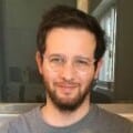 Headshot of man wearing t-shirt indoors