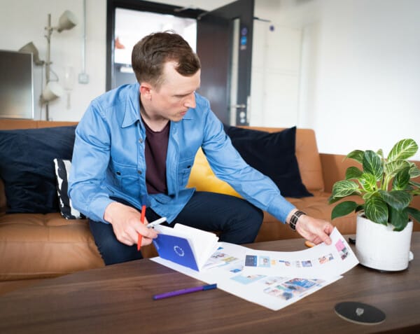 Piers Tincknell using print outs and notebooks for a WordPress and WooCommerce strategy session in office setting