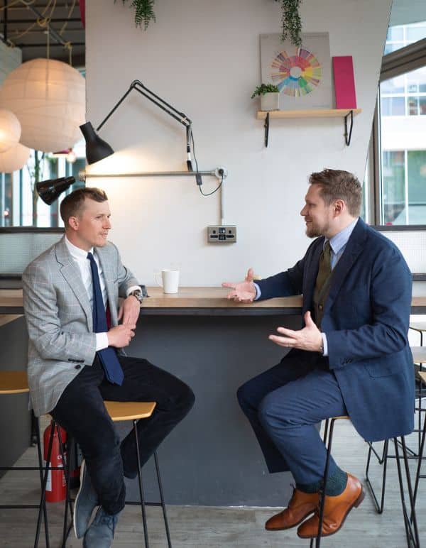 Business owners Piers and Dave sit opposite one another in a Bristol cafe