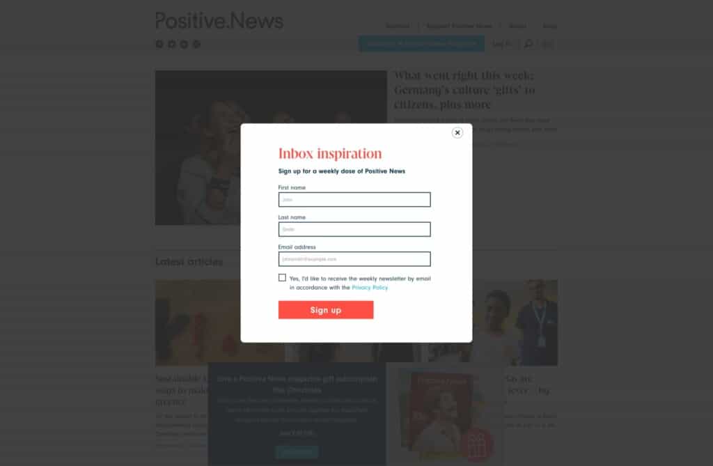 Screenshot of the Positive News WordPress and WooCommerce site with a pop-up encouraging newsletter sign ups