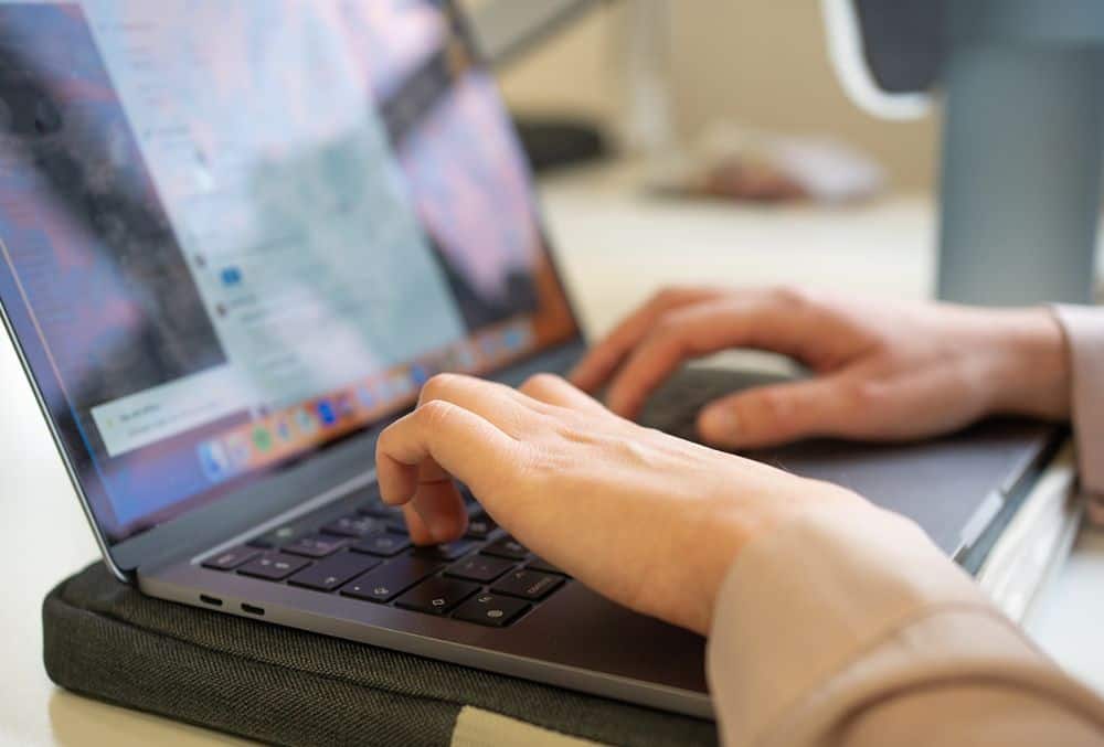 Hands working on laptop