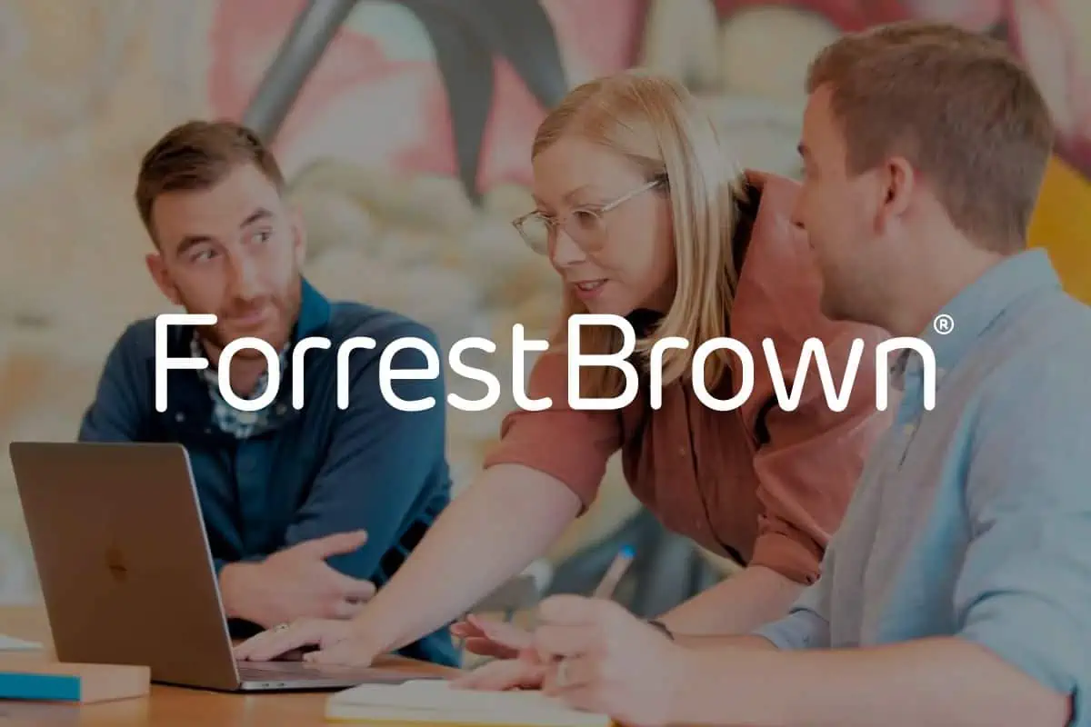 ForrestBrown logo in front of image of a discussion between three colleagues in front of a laptop and desk