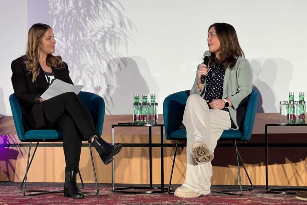 Mary Voelker and Tess Coughlan-Allen on stage at WooCommerce company conference