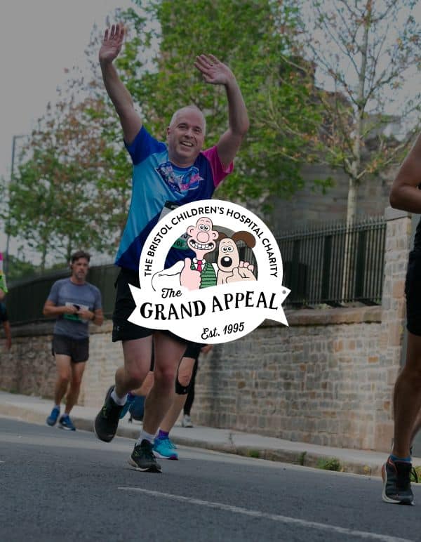 The Grand Appeal logo in front of image of runners fundraising for the charity in a race