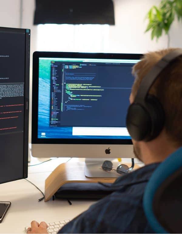 Developer working on computer screens