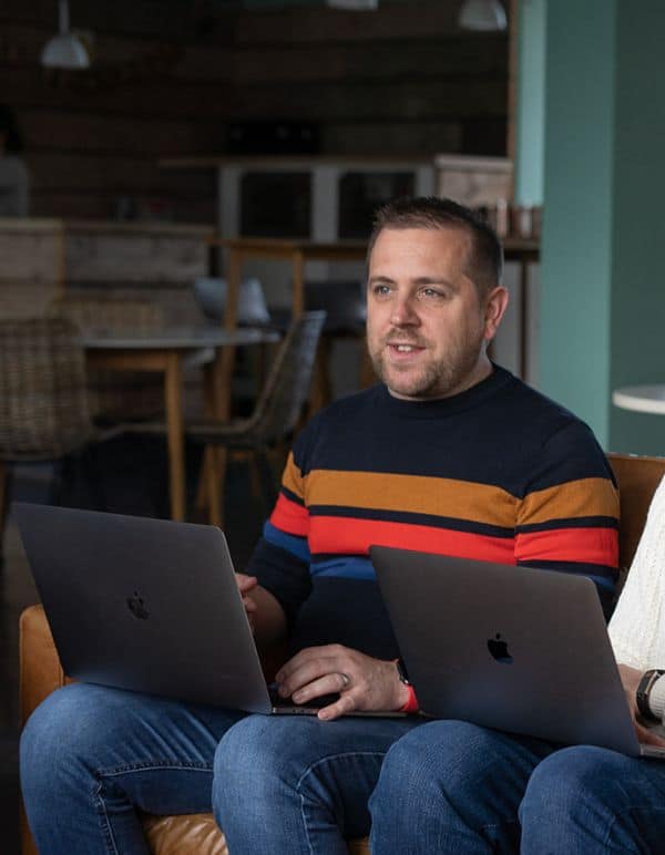 Matt sat with laptop in creative workspace as part of the team delivering website support and maintenance services in Bristol