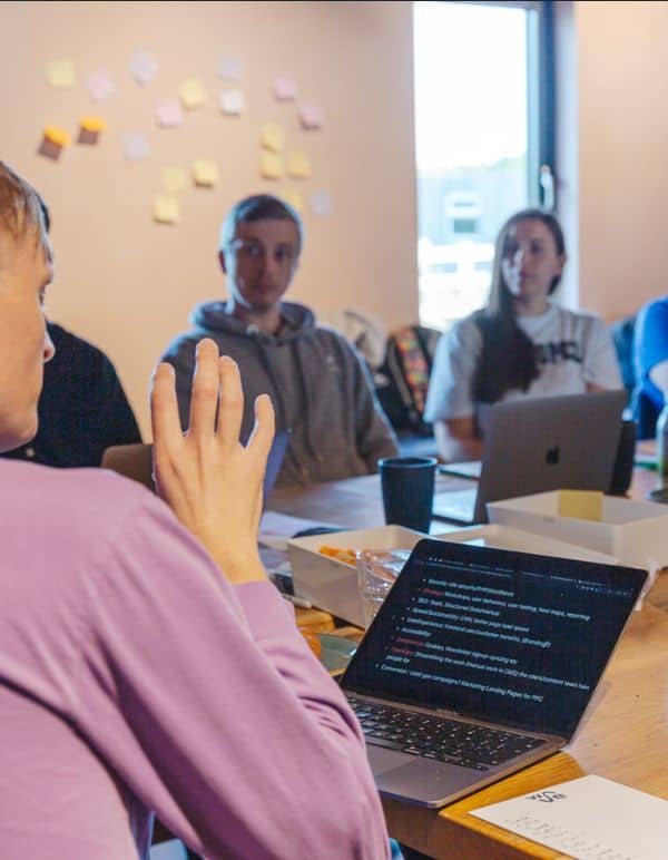 Team meeting with post-it notes and laptop