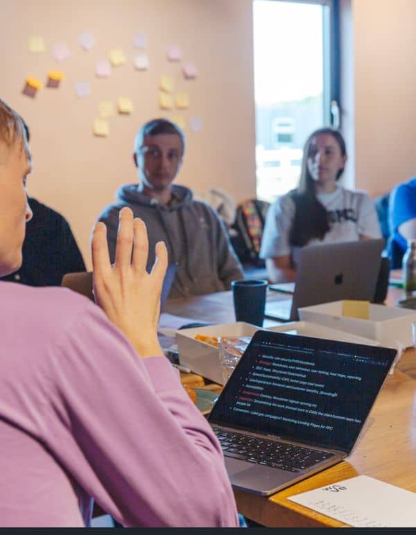 Team meeting with post-it notes and laptop