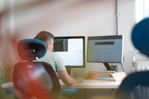 Developer sat at a desk working on a computer