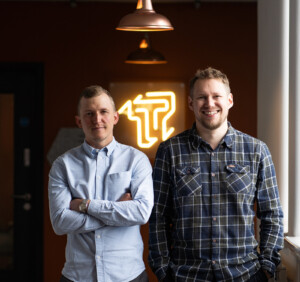 Atomic Smash founders standing in their office building